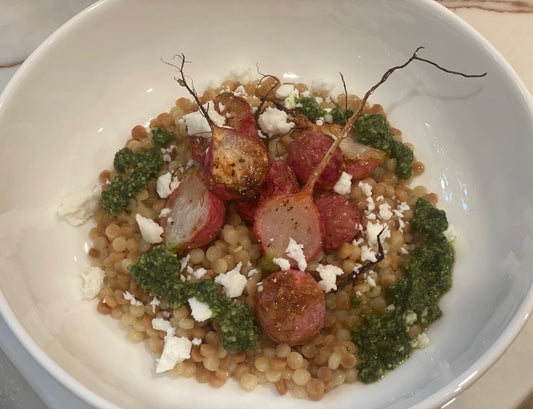 Roasted radishes with couscous and pesto in a bowl