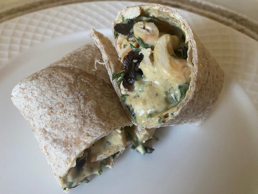 Coconut curry chicken salad with carrot tops in a wrap