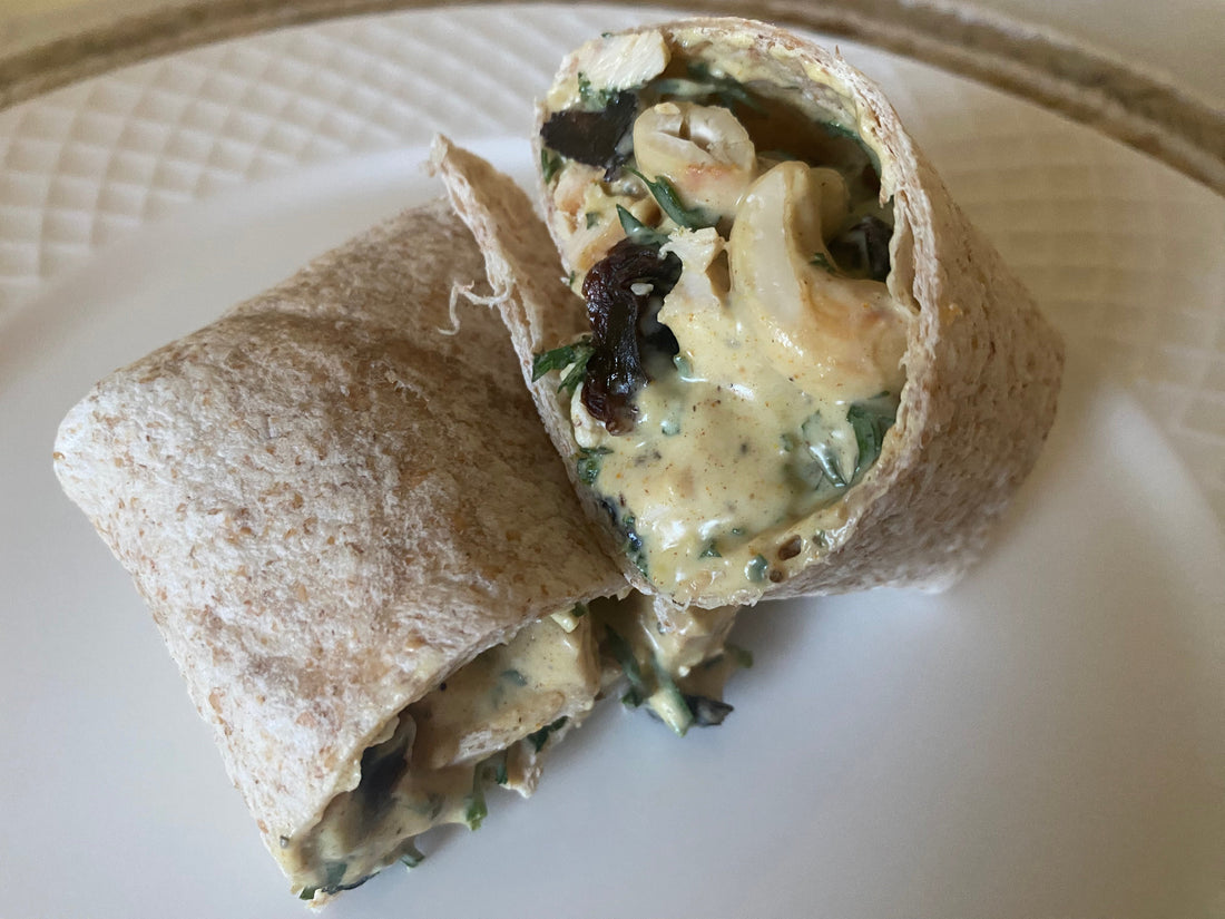 Coconut curry chicken salad with carrot tops in a wrap