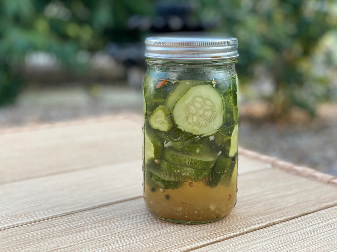 Cucumber slices in mason jar pickling to make sweet and spicy refrigerator pickles